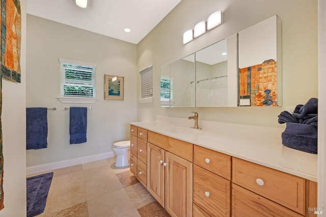 full bathroom with vanity, baseboards, walk in shower, tile patterned floors, and toilet