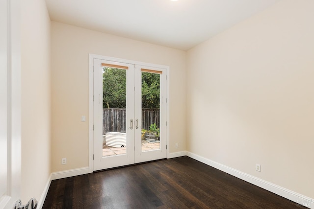 spare room with dark hardwood / wood-style flooring and french doors