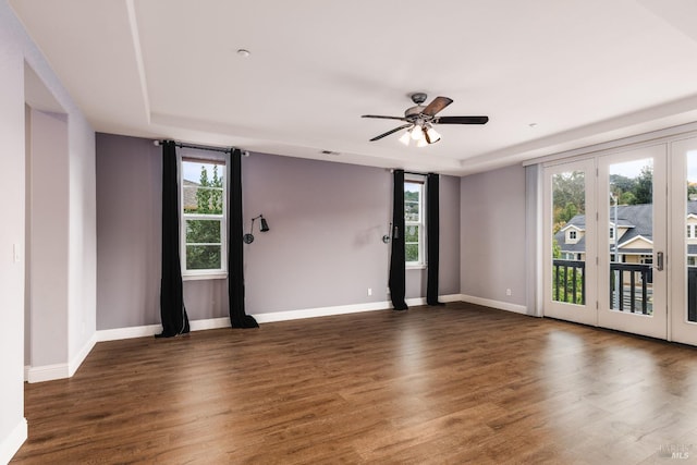 unfurnished room with ceiling fan, dark hardwood / wood-style floors, and a healthy amount of sunlight