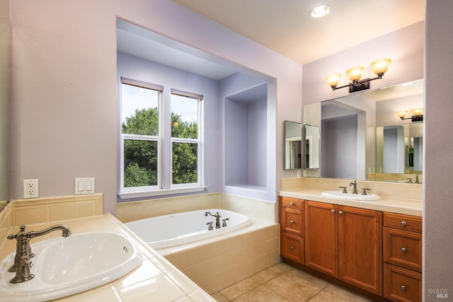 bathroom featuring tile patterned floors, tiled tub, and vanity