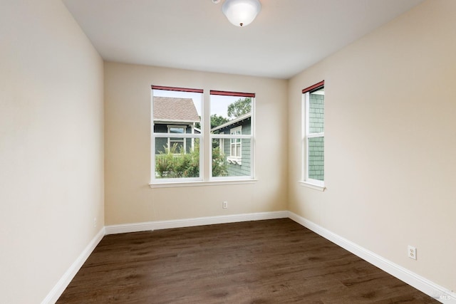 unfurnished room featuring dark wood-type flooring