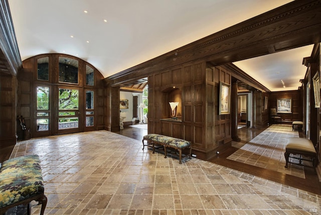 interior space with crown molding and wood walls