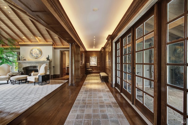 corridor with french doors, dark hardwood / wood-style floors, wooden ceiling, crown molding, and ornate columns