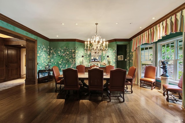 dining space featuring crown molding, hardwood / wood-style floors, and a notable chandelier