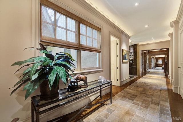 hall with crown molding and hardwood / wood-style flooring