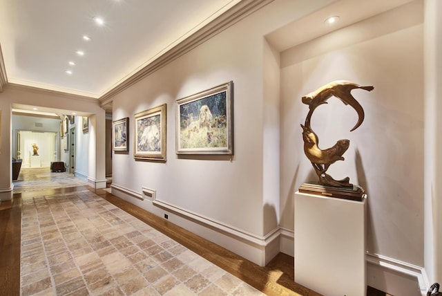 hallway with crown molding and light hardwood / wood-style flooring