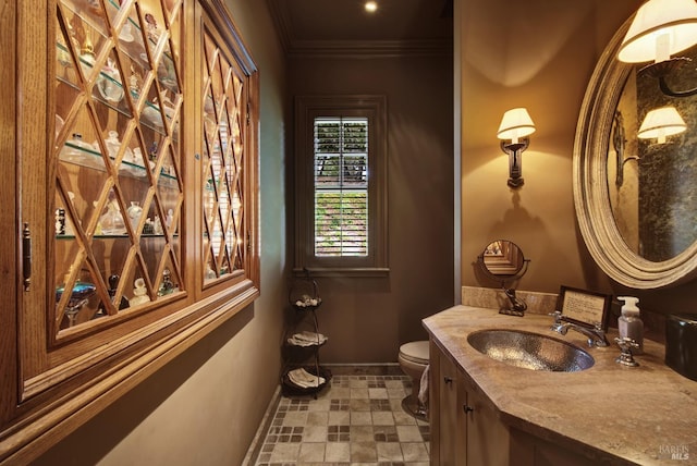 bathroom featuring crown molding, vanity, and toilet