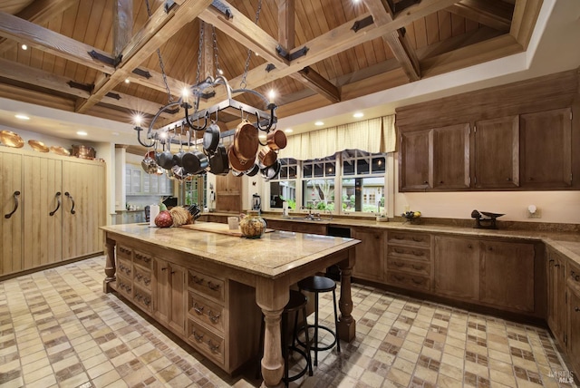 kitchen with wooden ceiling, a kitchen island, beamed ceiling, and a notable chandelier