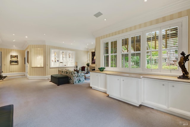 kitchen featuring light carpet, white cabinetry, and ornamental molding