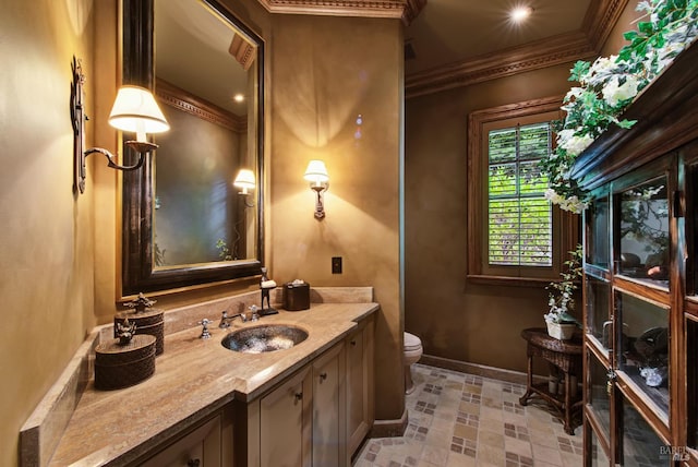 bathroom featuring ornamental molding, vanity, and toilet