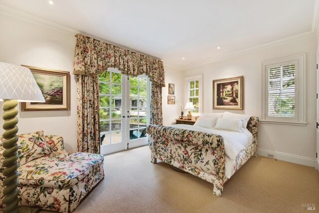 carpeted bedroom with crown molding, french doors, and access to exterior