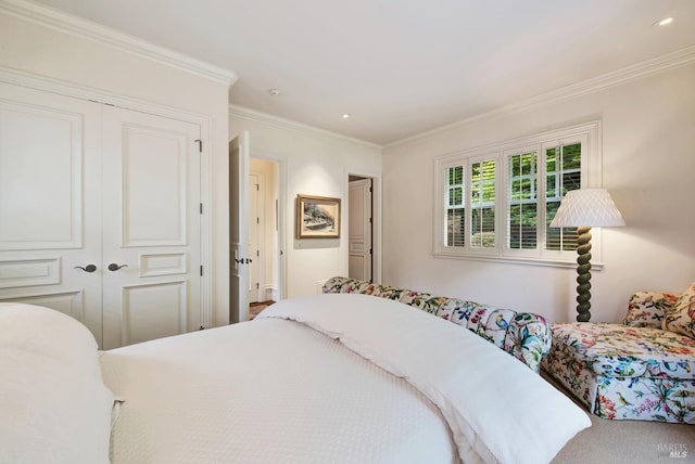 bedroom featuring ornamental molding, carpet, and a closet