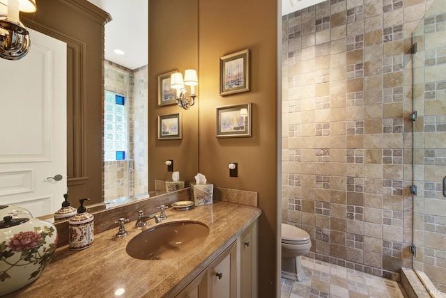 bathroom with tile patterned flooring, vanity, toilet, and a shower with door