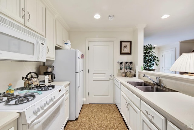 kitchen with white cabinets, crown molding, sink, and white appliances