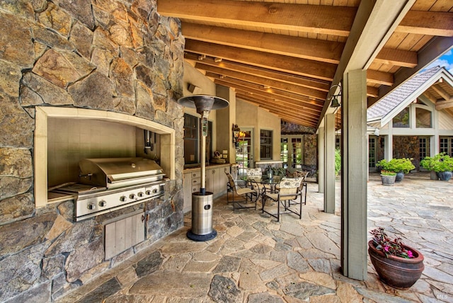 view of patio with an outdoor kitchen and a grill