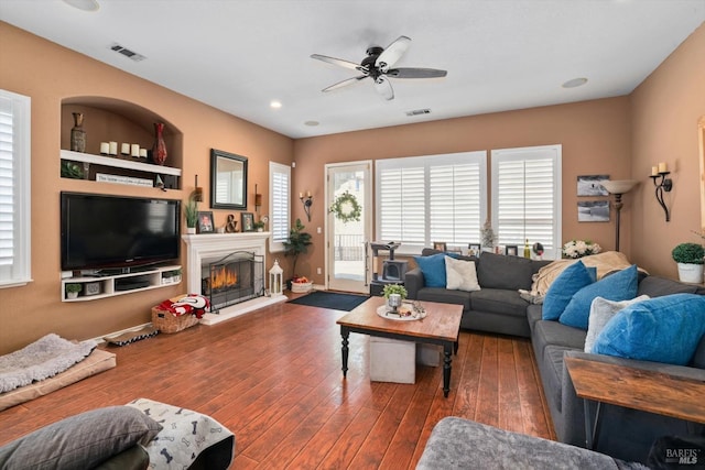 living room with ceiling fan and dark hardwood / wood-style floors