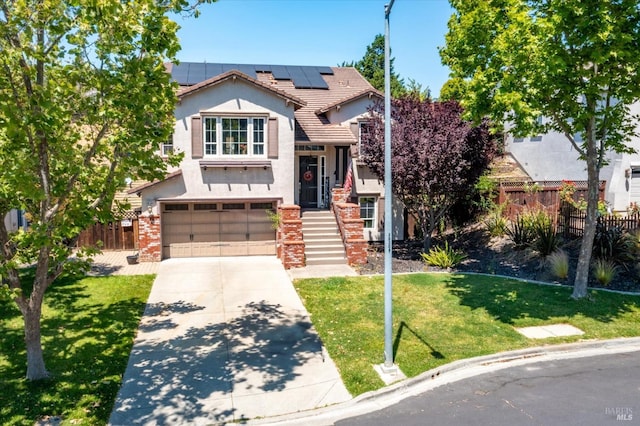 view of front of house featuring a garage, solar panels, and a front yard