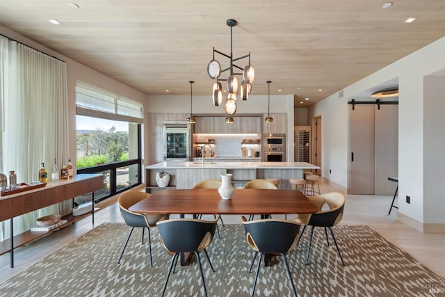 dining space with wooden ceiling, baseboards, a barn door, and recessed lighting