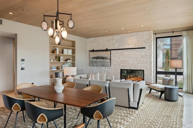 dining area with a stone fireplace, wooden ceiling, built in features, and recessed lighting