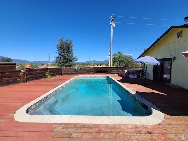 view of pool with a deck with mountain view