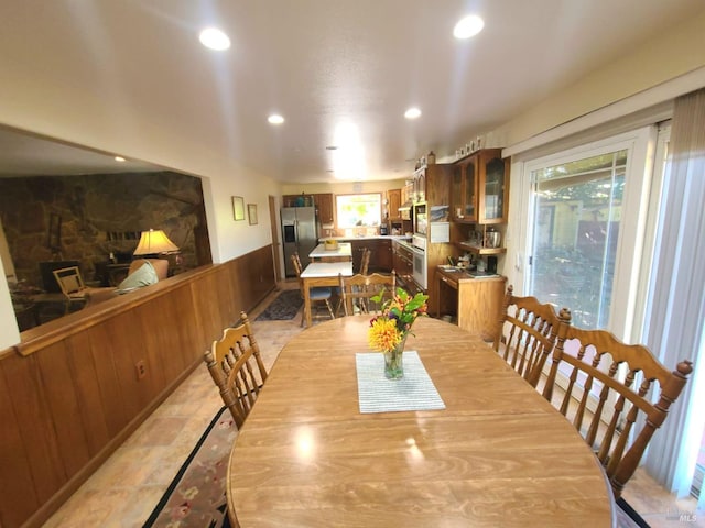 dining room featuring a fireplace and plenty of natural light