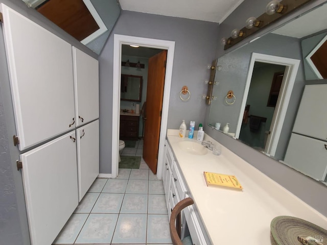 bathroom with vanity, toilet, and tile patterned floors