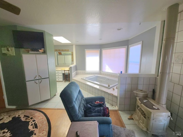 bathroom featuring tile walls, tile patterned flooring, and tiled tub