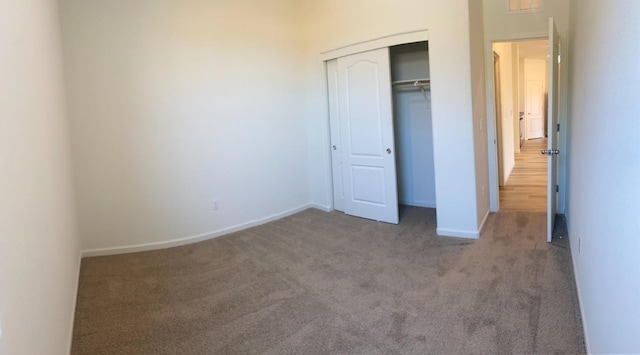 unfurnished bedroom with carpet and a closet