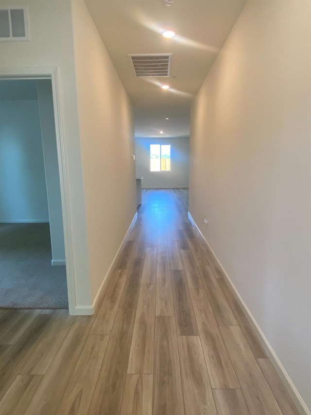 hall with light hardwood / wood-style flooring