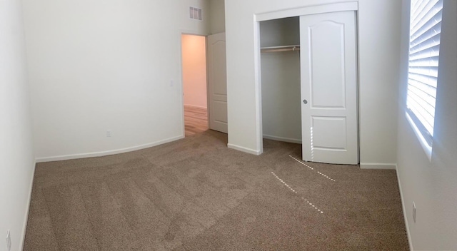 unfurnished bedroom featuring carpet floors and a closet