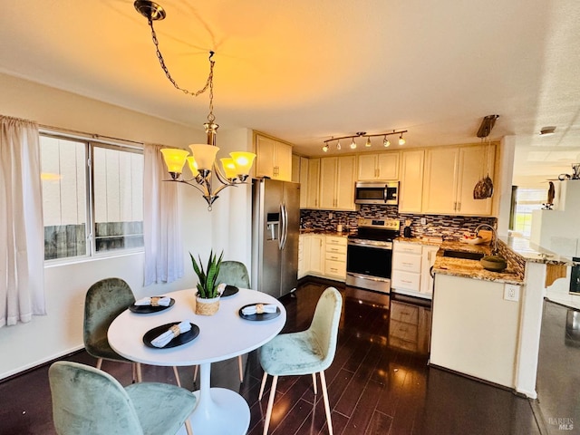 dining area featuring a notable chandelier, dark hardwood / wood-style floors, and sink