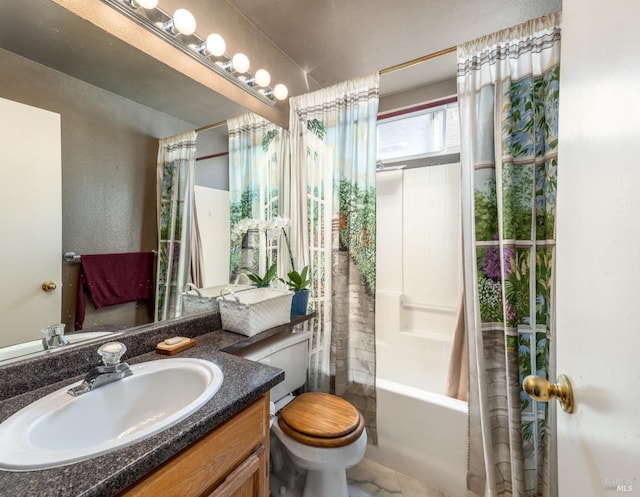 full bathroom with vanity, shower / tub combo, and toilet