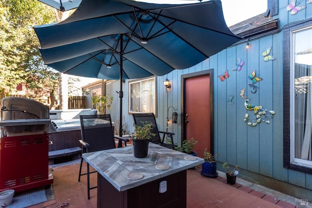 view of patio / terrace with a hot tub