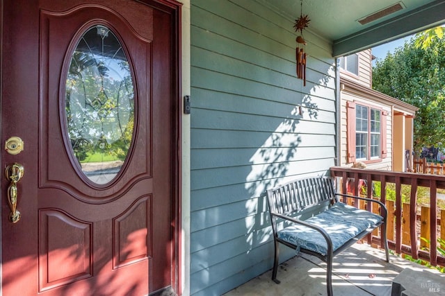 view of exterior entry featuring a porch