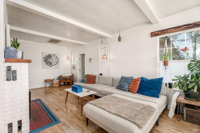 living room with beamed ceiling and light hardwood / wood-style flooring