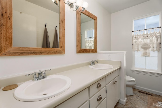 bathroom with vanity, tile patterned flooring, and toilet