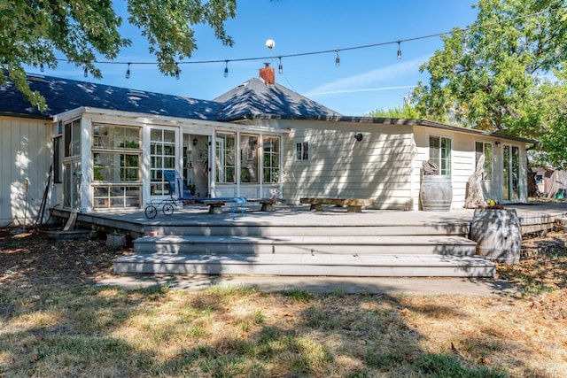 rear view of property with a wooden deck