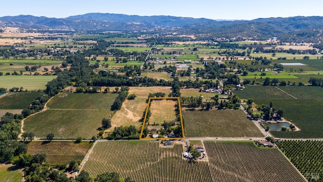 drone / aerial view featuring a mountain view and a rural view