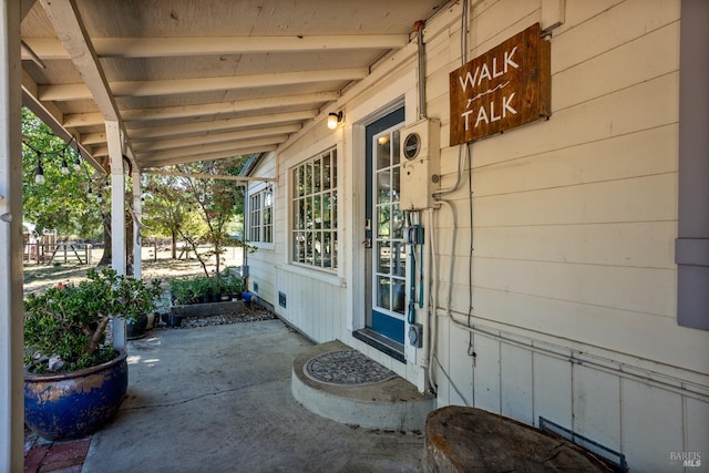 view of exterior entry with a porch