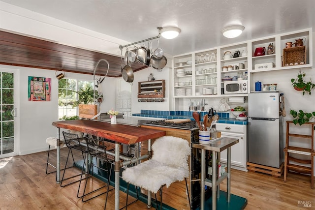 dining space with light hardwood / wood-style flooring and a chandelier