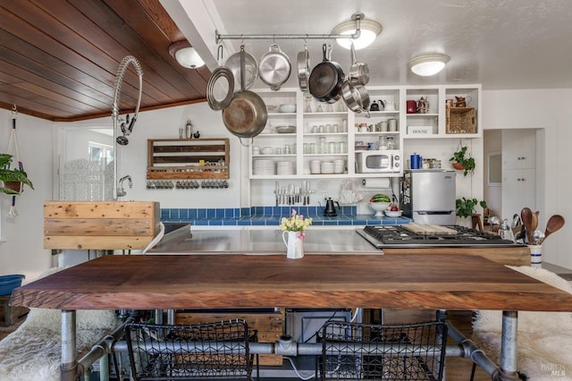 kitchen featuring stainless steel appliances and wooden ceiling