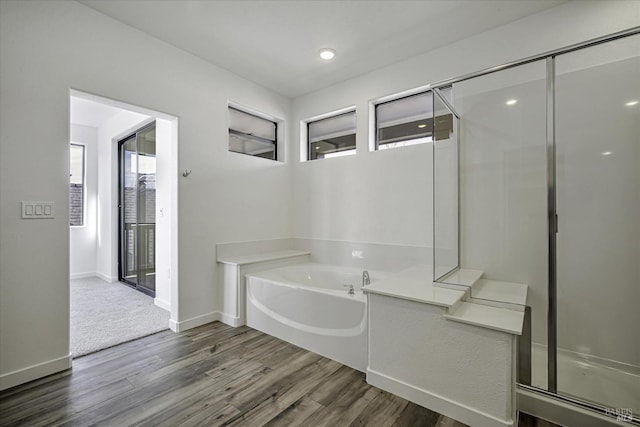 8953 Camino Colegio Rd, Rohnert Park, CA 94928 - full bath featuring wood finished floors, a bath, baseboards, a shower with shower door, and recessed lighting