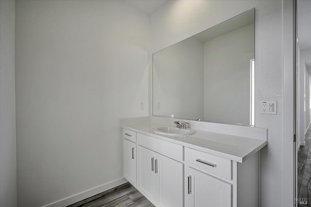 bathroom with vanity and wood-type flooring