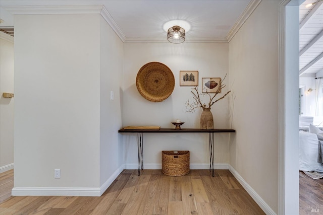 hall with light hardwood / wood-style flooring and ornamental molding