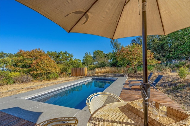 view of pool with ceiling fan and a patio area