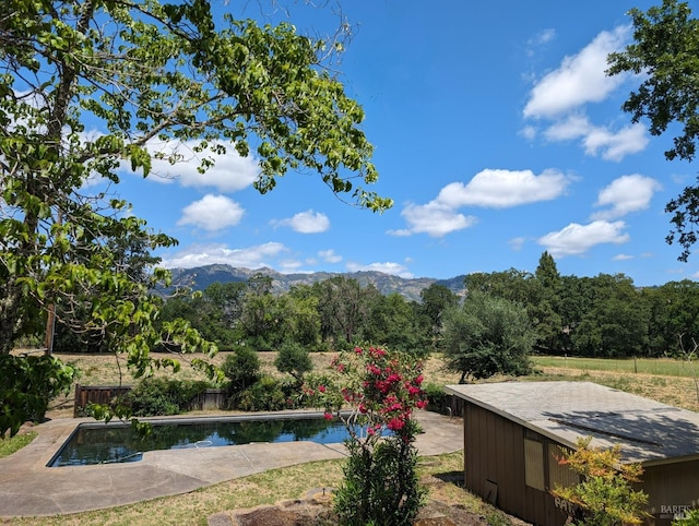 exterior space with a mountain view and a patio area