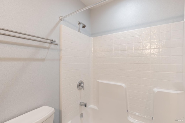 bathroom with shower / bathtub combination and toilet