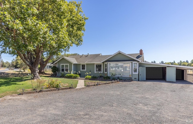 ranch-style home with a front yard and a carport