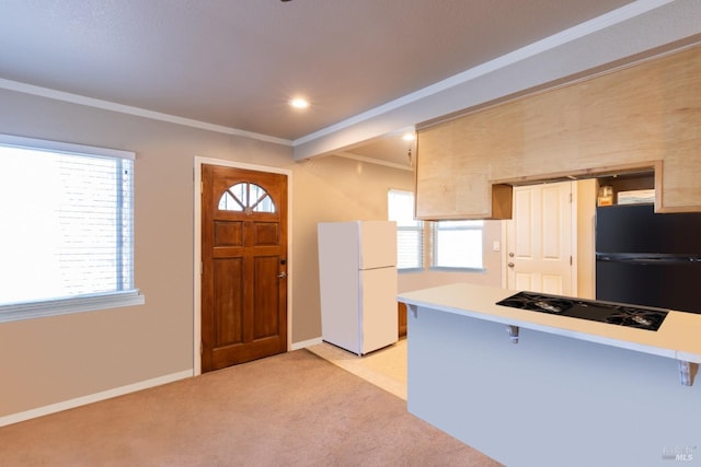 kitchen with light colored carpet, a breakfast bar area, and black appliances