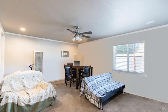 living area featuring ceiling fan, a textured ceiling, crown molding, and carpet